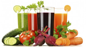 Glasses with fresh vegetable juices isolated on white